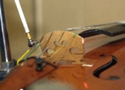 A laser is used to record the response of the bridge to the hammer's impulse