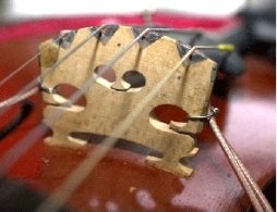 Tranducers under the strings are used to measure the player's input